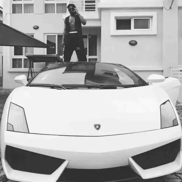 Runtown Climbs On His Lamborghini In New Picture 